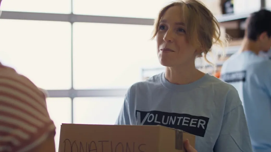 A volunteer receiving a box of food donations